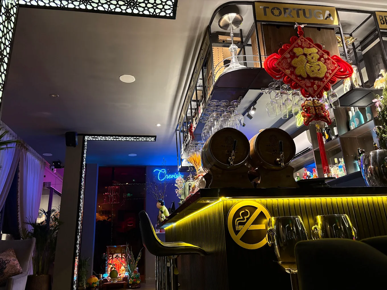 Chilllayla bar interior with ambient blue lighting and neon signs