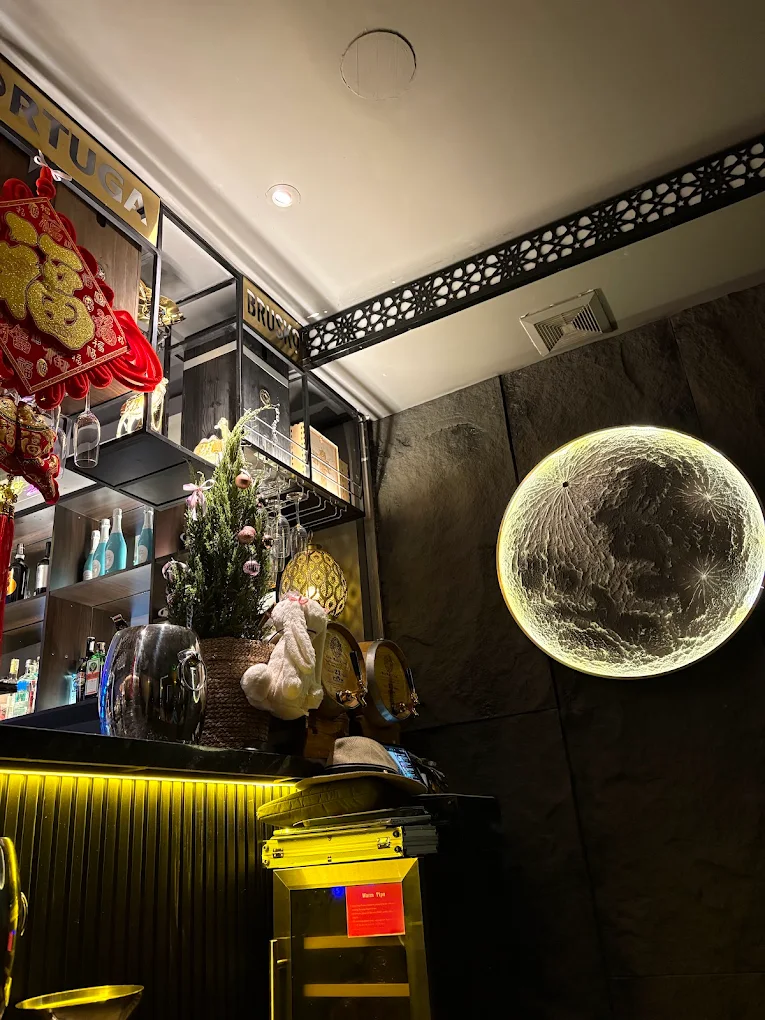 Moon lamp decor with ornate bar shelves and festive decorations