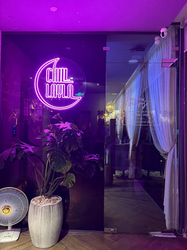 Chilllayla entrance with purple neon moon logo sign