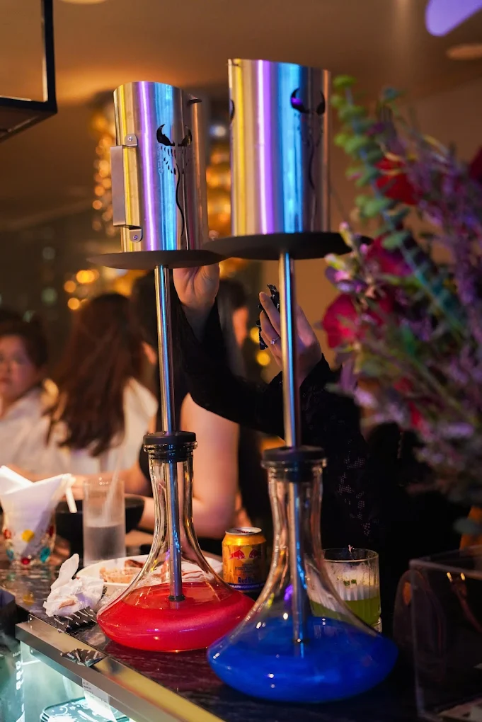 Colorful hookah pipes with LED lights and lively atmosphere