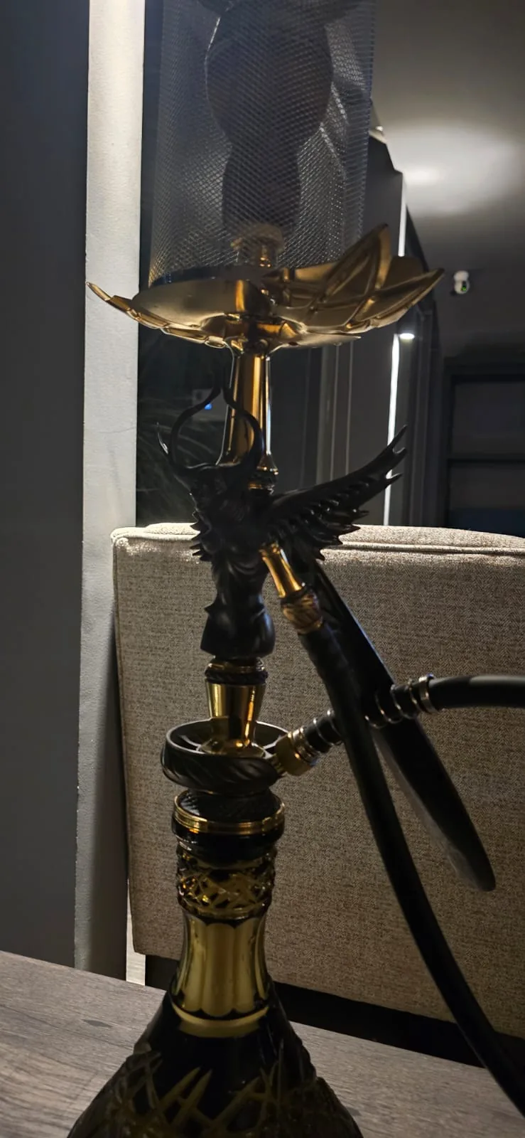 Black and gold angel hookah on a lounge table at Natasha Noir